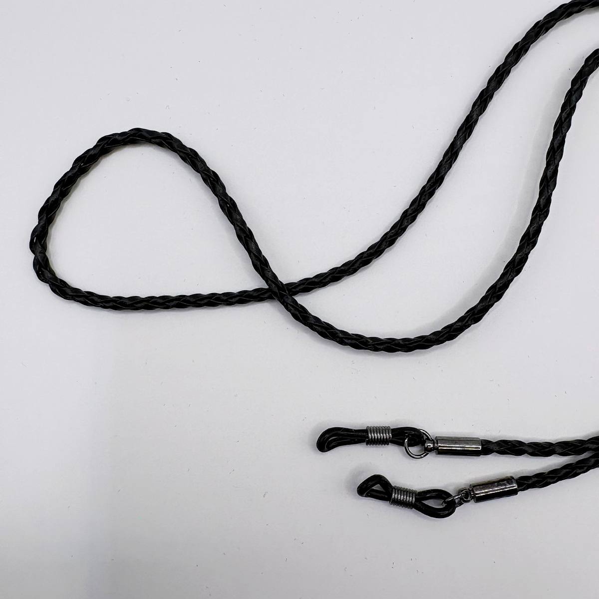 Black braided lanyard with metal clasps on a white background