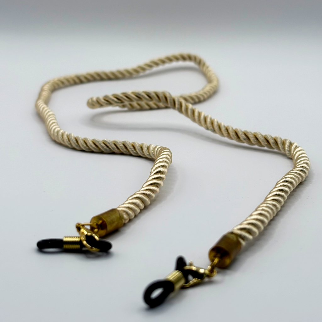 Beige rope lanyard with gold connectors on a light gray background