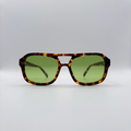 Close-up of vintage-inspired frame crafted from premium brown tortoiseshell acetate and yellow green tinted lensesfrom independent rock ’n’ roll–inspired eyewear brand Dirty Rocker. David Bowie inspired sunglasses.