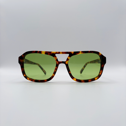 Close-up of vintage-inspired frame crafted from premium brown tortoiseshell acetate and yellow green tinted lensesfrom independent rock ’n’ roll–inspired eyewear brand Dirty Rocker. David Bowie inspired sunglasses.