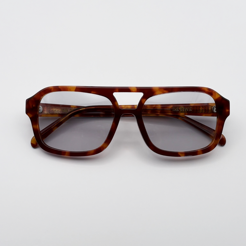 Close-up of vintage-inspired frame crafted from premium brown tortoiseshell acetate and grey-tinted lensesfrom independent rock ’n’ roll–inspired eyewear brand Dirty Rocker. David Bowie inspired sunglasses.