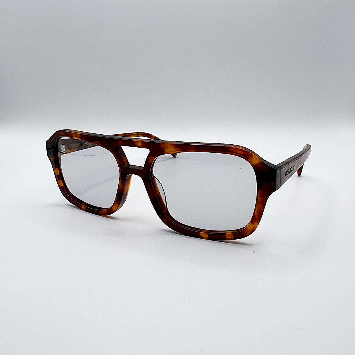 Close-up of vintage-inspired frame crafted from premium brown tortoiseshell acetate and grey-tinted lensesfrom independent rock ’n’ roll–inspired eyewear brand Dirty Rocker. David Bowie inspired sunglasses.