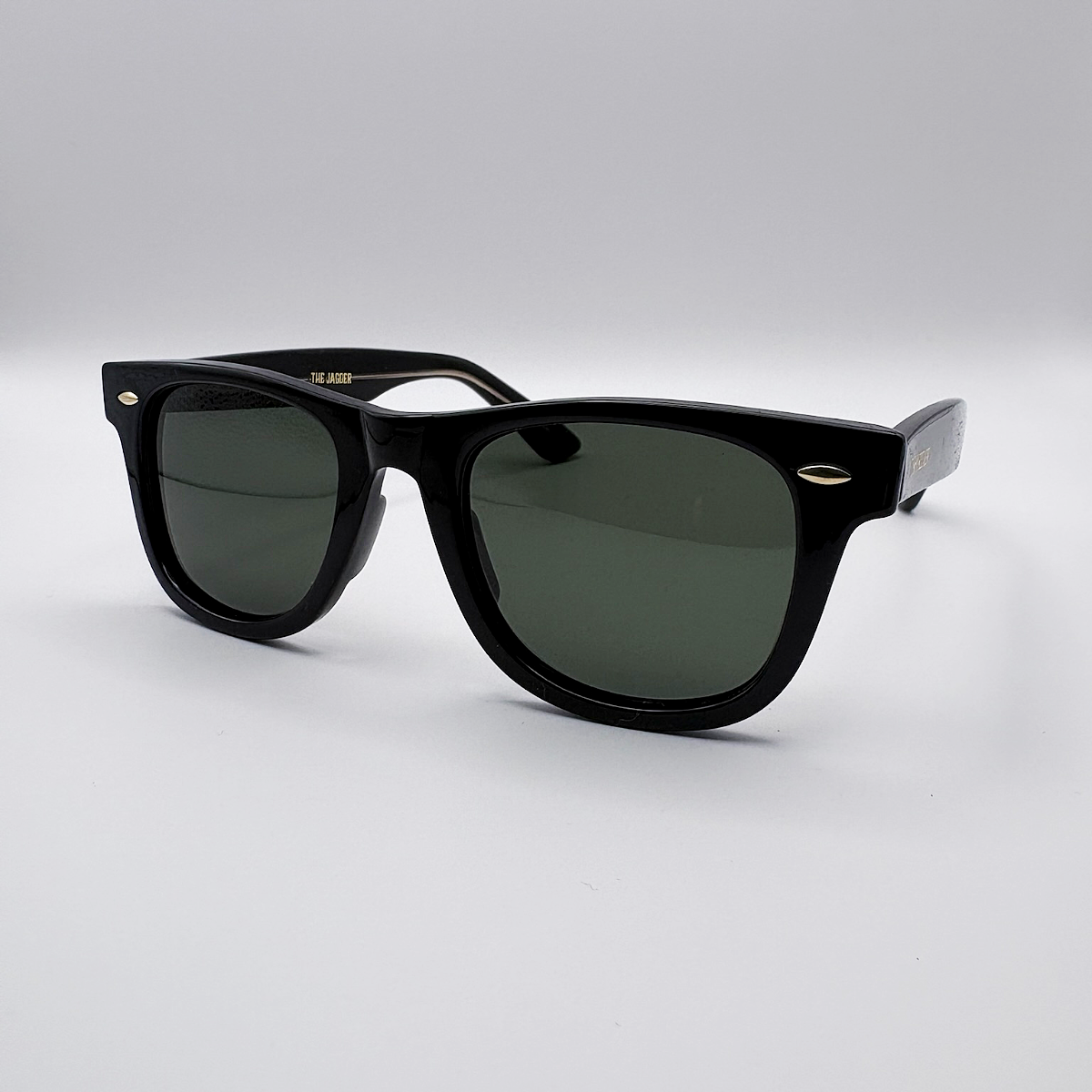 Close-up of vintage-inspired solid black Wayfarer frame with a high-gloss finish and black polarised lenses unisex vintage inspired tinted sunglasses from independent rock ’n’ roll–inspired eyewear brand Dirty Rocker 