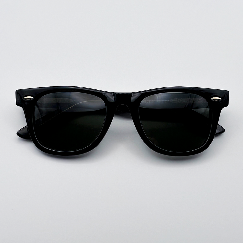 Close-up of vintage-inspired solid black Wayfarer frame with a high-gloss finish and black polarised lenses unisex vintage inspired tinted sunglasses from independent rock ’n’ roll–inspired eyewear brand Dirty Rocker 