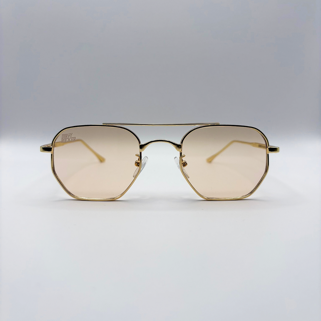 Gold-framed sunglasses with a light brown lens on a light gray background