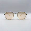Gold-framed sunglasses with a light brown lens on a light gray background